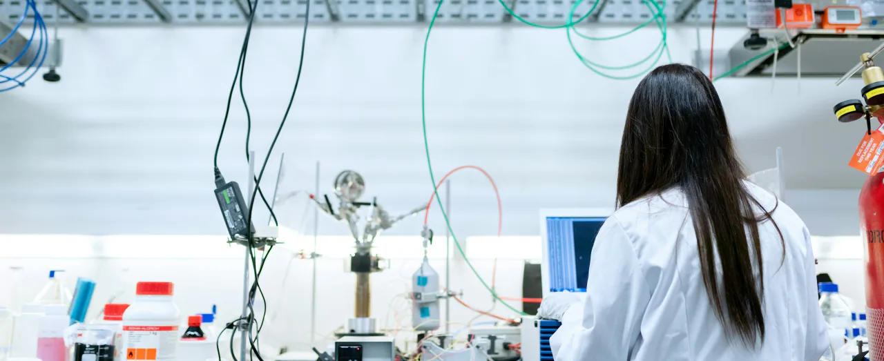 PhD researcher working in a modern laboratory abroad