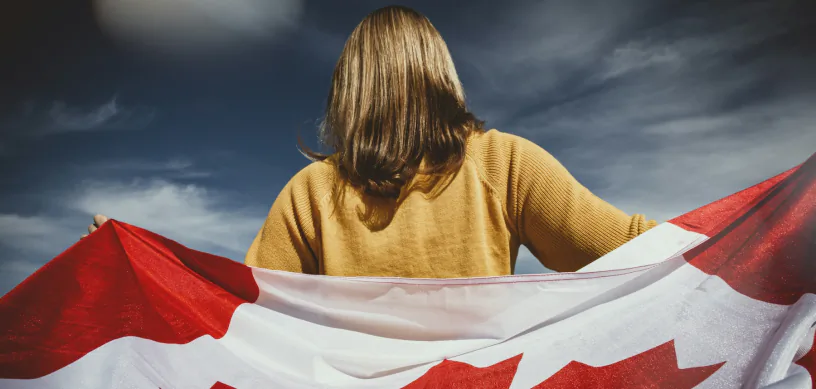International student holding the Canadian flag