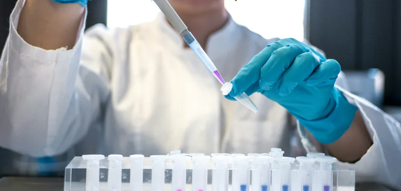 Pharmaceutical science student pipetting samples in a university laboratory