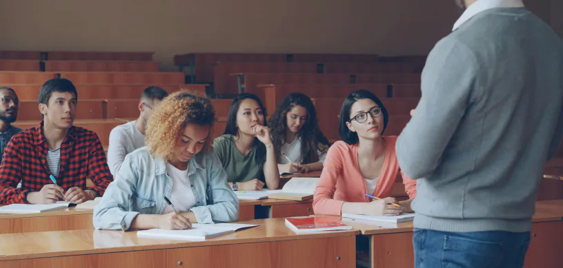Professor teaching students in a US university lecture hall